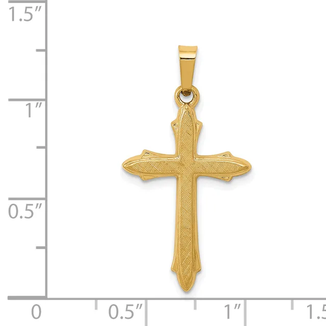 A gold cross pendant with textured surface and pointed ends, shown next to a ruler measuring approximately 1.25 inches in height.
