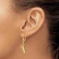 A person wearing a gold pineapple-shaped pendant earring on a lever-back hook, shown from the side profile of their ear.
