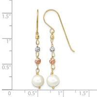 Gold fishhook earrings with white pearl drops, small rose gold and silver tone beads, and gold chain links, shown against a measurement ruler.