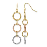 Pair of dangling earrings with three stacked textured rings in yellow gold, rose gold, and silver, suspended from gold fishhook wires.