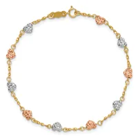 A gold chain bracelet with alternating rose gold and silver textured heart charms evenly spaced throughout, fastened with a gold lobster clasp.