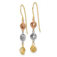 Pair of dangling earrings with gold ear wires featuring three textured metal knot beads in rose gold, silver, and yellow gold suspended vertically on each earring.