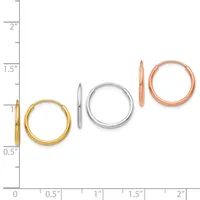 Four polished metal hoop earrings in gold, silver, and rose gold displayed next to a measurement scale showing sizes ranging from approximately 0.5 inches to 2 inches in diameter.