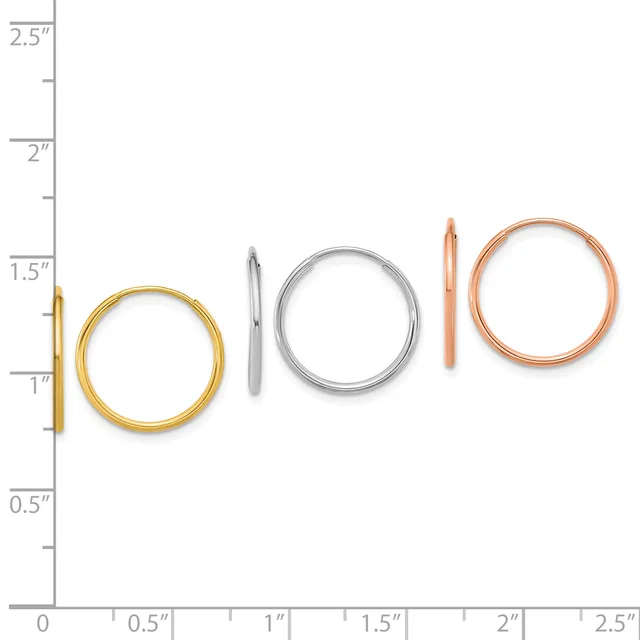 Five metal bangles in graduated sizes displayed against a ruler, ranging from approximately one inch to two and a half inches in diameter, in gold, silver, and rose gold finishes.