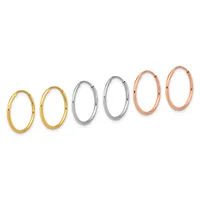Six oval hoop earrings arranged in a row, progressing from smaller yellow gold pairs on the left to larger silver pairs in the middle to larger rose gold pairs on the right.