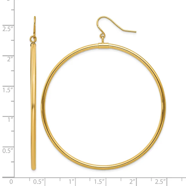 Gold-toned hoop earrings with fish hook closures, displayed next to a ruler showing approximately two inches in diameter.