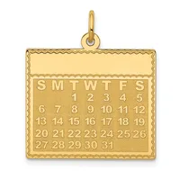 Gold pendant in the shape of a calendar showing all dates of a month with days of the week abbreviated at the top.