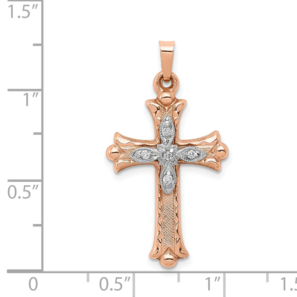 Rose gold cross pendant with diamond accents and ornate floral detailing, shown against a ruler measuring approximately 1.25 inches in height.
