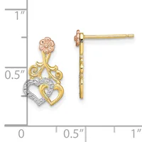 Two-tone gold dangle earrings featuring an ornate floral top with scrollwork and interlocking hearts below, one outlined in diamond accents, shown next to a measurement ruler.