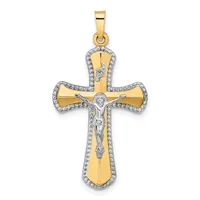 A two-tone gold crucifix pendant with a white gold or silver corpus figure and diamond-accented border around the cross arms and shaft.