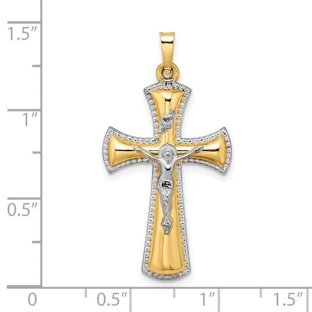 Two-tone gold cross pendant with white diamond accents around the border and a crucifix figure in the center, displayed against a measurement scale.