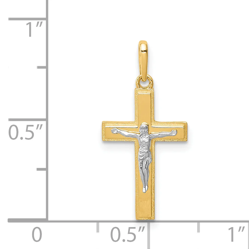 A gold cross pendant with a silver-toned crucifix figure in the center, shown next to a ruler indicating the pendant is approximately 0.75 inches wide and 1 inch tall.