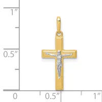 A gold cross pendant with a silver-toned crucifix figure in the center, shown next to a ruler indicating the pendant is approximately 0.75 inches wide and 1 inch tall.