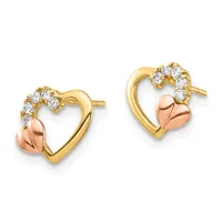 A pair of gold heart-shaped stud earrings with a rose gold polished heart charm suspended below and cubic zirconia stones arranged along the top curved edge.