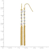 Pair of gold-tone dangle earrings with silver-colored beads and long chain tassels, displayed on a measurement scale.