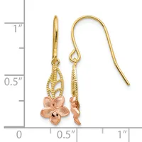 Pair of gold fish hook earrings with textured teardrop caps and rose gold flower charms, displayed against a ruler showing approximately one inch in length.