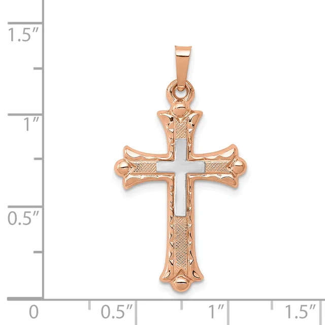 Rose gold cross pendant with textured surface and flared ends, shown next to a measurement scale indicating approximately one inch in width.