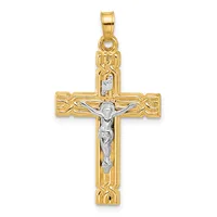 A two-tone gold crucifix pendant with ornate decorative borders on the arms and a silver-toned corpus figure, suspended from a gold bail.