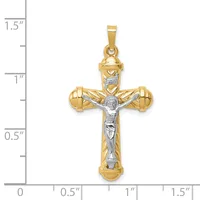 Two-tone gold crucifix pendant with white gold corpus figure, featuring rounded shouldered cross design with small hallmark, shown next to measurement scale.