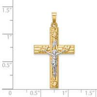 Gold two-tone crucifix pendant with textured band pattern and silver-tone corpus, shown against a measurement scale indicating approximately 1.25 inches in height.