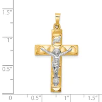 Two-tone gold crucifix pendant with a polished yellow gold cross and white gold corpus figure, shown with a measurement scale indicating approximately 1.25 inches in height.