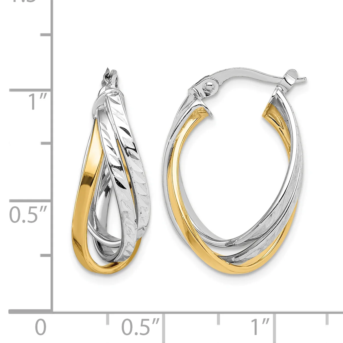 Two-tone twisted oval hoop earrings with white and yellow gold sections, displayed next to a measurement scale showing approximately one inch in length.