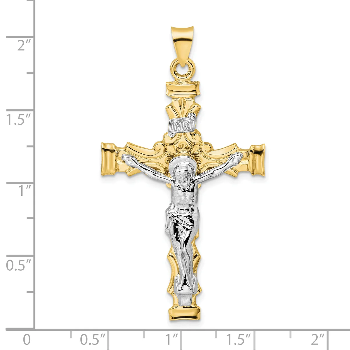 Two-tone gold and silver crucifix pendant with ornate scrollwork at the top and sides, shown against a ruler measuring approximately two inches tall.