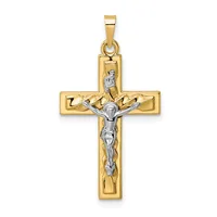 Two-tone gold crucifix pendant with polished yellow gold cross and white gold corpus figure, shown suspended from a rectangular bail.