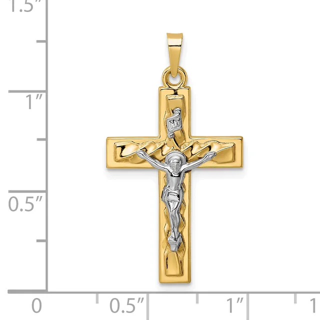 Two-tone gold crucifix pendant with white gold corpus figure, shown next to a ruler measuring approximately 1.25 inches in height.