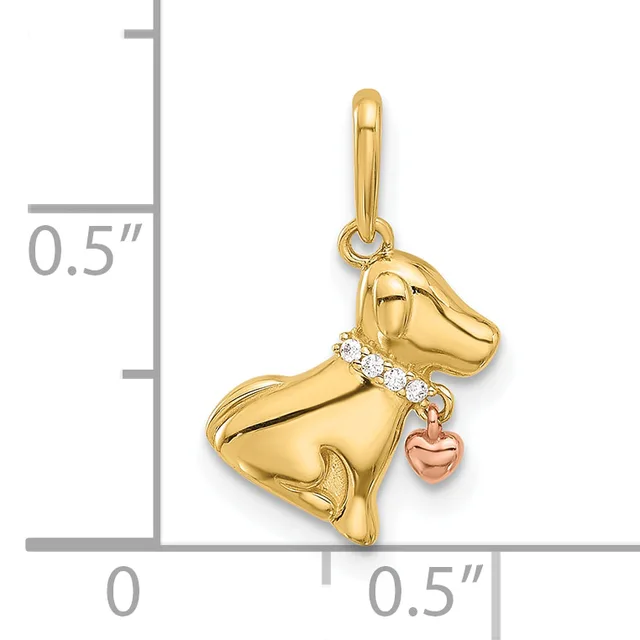 Gold dog charm with cubic zirconia collar and small rose gold heart dangling from its side, shown against a measurement scale.