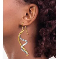 Two-tone twisted drop earrings in gold and silver with fish hook wires, shown worn on a person's ear.