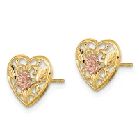A pair of gold heart-shaped stud earrings with filigree detailing and rose gold floral centers, shown from the front.