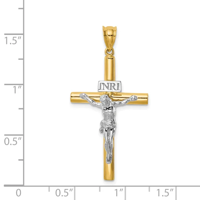 Two-tone gold crucifix pendant with silver-colored corpus and INRI plaque, displayed against a measurement scale showing approximately 1.25 inches in height.