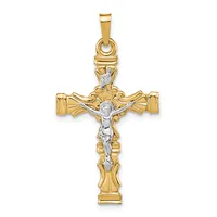Two-tone gold crucifix pendant with ornate scrollwork at the top and sides, featuring a white gold corpus figure.