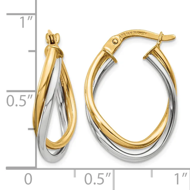Two-tone oval hoop earrings with intertwined yellow and white gold bands, shown next to a ruler indicating approximately one inch in length.