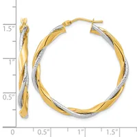Two-tone twisted hoop earrings with yellow and white gold coloring, measuring 1.5 inches in length, shown with a measurement scale.