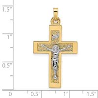 Gold crucifix pendant with textured gold cross and silver-toned corpus figure, shown against a ruler measuring approximately 1.25 inches tall.