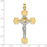 Two-tone gold and silver crucifix pendant with textured gold cross arms and a polished silver corpus, displayed against a measurement ruler showing approximately 2.5 inches in length.