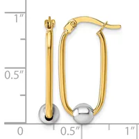 Gold-toned hollow oval hoop earrings with polished silver-toned spherical accents at the bottom, shown next to a measurement scale.
