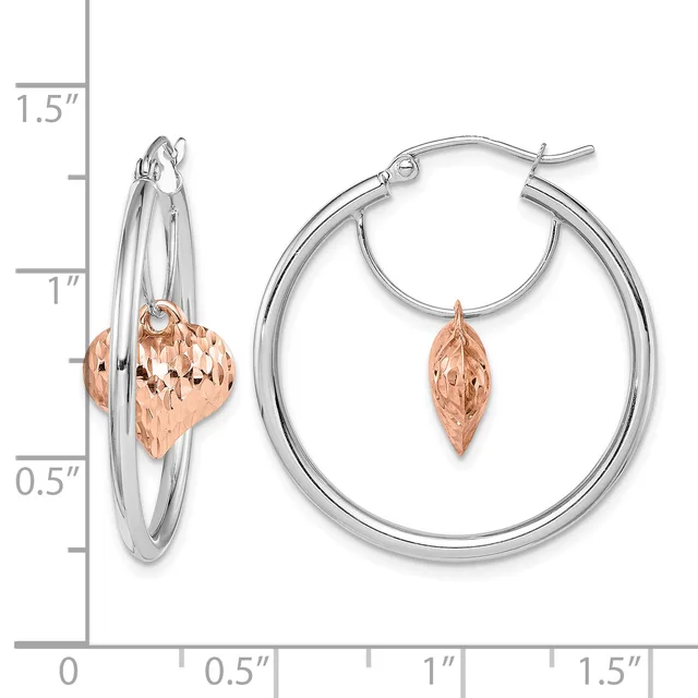 Two-tone hoop earrings featuring silver outer hoops with rose gold textured leaf charms, displayed next to a measurement scale showing approximately one and one-half inches in length.