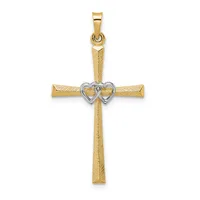 A gold cross pendant with a textured finish and a two-toned heart at its center, displayed against a white background.