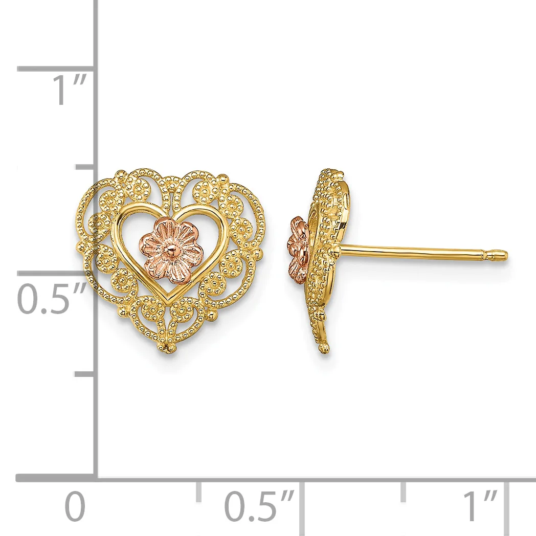 A pair of gold heart-shaped stud earrings with filigree detailing and a small rose gold flower in the center, shown front and side view against a measurement scale.