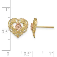 A pair of gold heart-shaped stud earrings with filigree detailing and a small rose gold flower in the center, shown front and side view against a measurement scale.