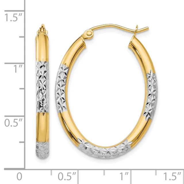 Two-tone gold hoop earrings with textured white gold lower sections, shown next to a measurement scale indicating approximately one inch in length.