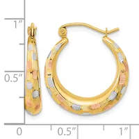 Pair of gold hoop earrings with textured and smooth surfaces in yellow, white, and rose gold tones, displayed next to a measurement ruler.