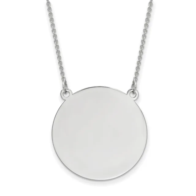 A polished silver circular pendant hangs from a delicate twisted silver chain against a white background.