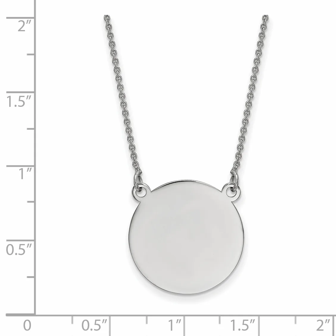 Silver circular pendant on a thin chain necklace, shown against a ruler measuring approximately 2 inches in length.