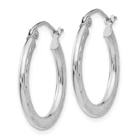 A pair of polished silver hoop earrings with a smooth, slightly textured finish and hinged closures, displayed against a white background.