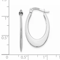 A pair of polished silver oval hoop earrings with a hinged closure, displayed next to a ruler showing approximately one inch in length.