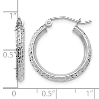 Pair of silver hoop earrings with textured diamond-cut surface, approximately one inch in diameter, shown with measurement scale.